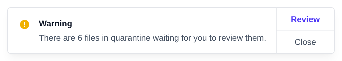 Warning toast saying how many files are in quarantine, with a Review button that opens the Quarantine page