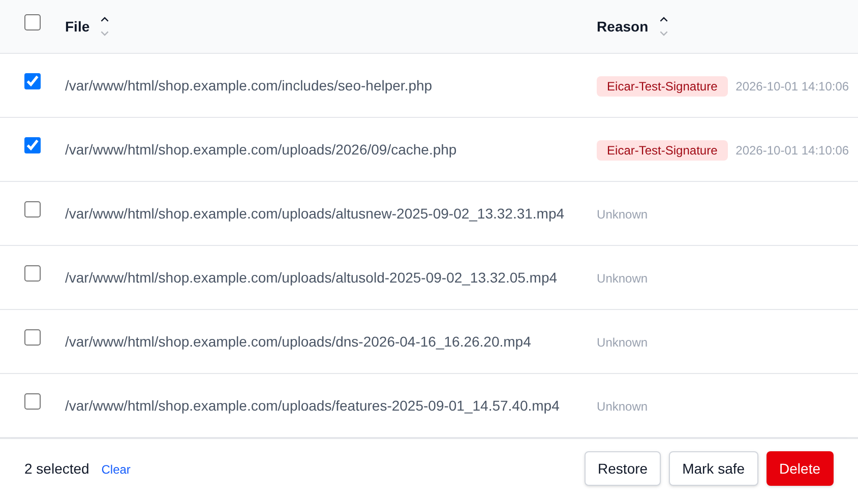 Two quarantined files selected with the bulk actions bar offering Restore, Mark safe and Delete