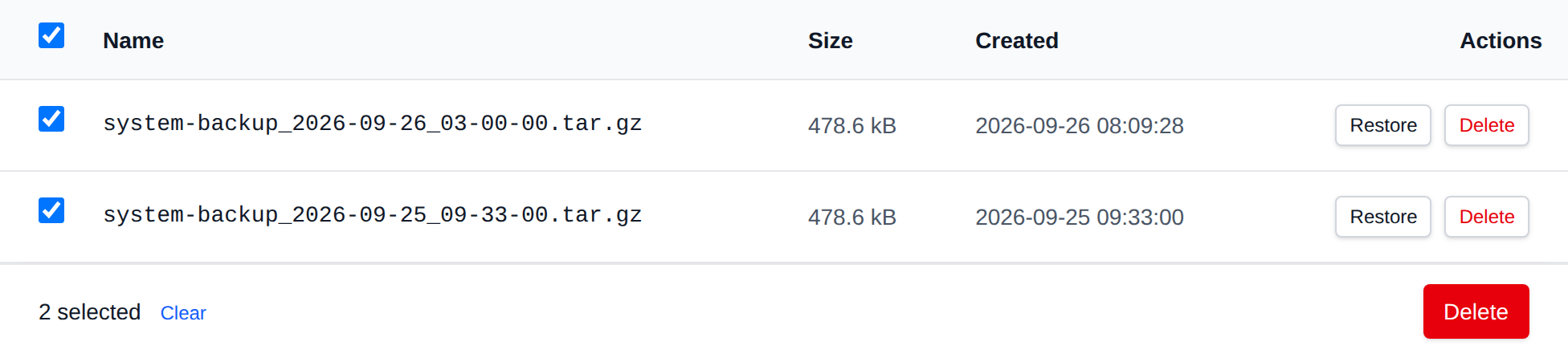 Two system backup archives selected with the bulk actions bar offering Delete