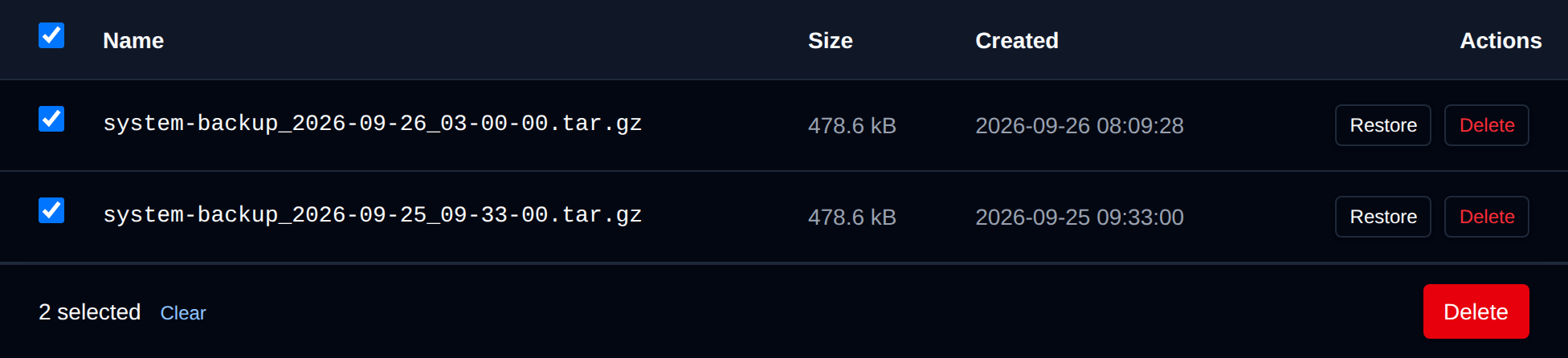Two system backup archives selected with the bulk actions bar offering Delete