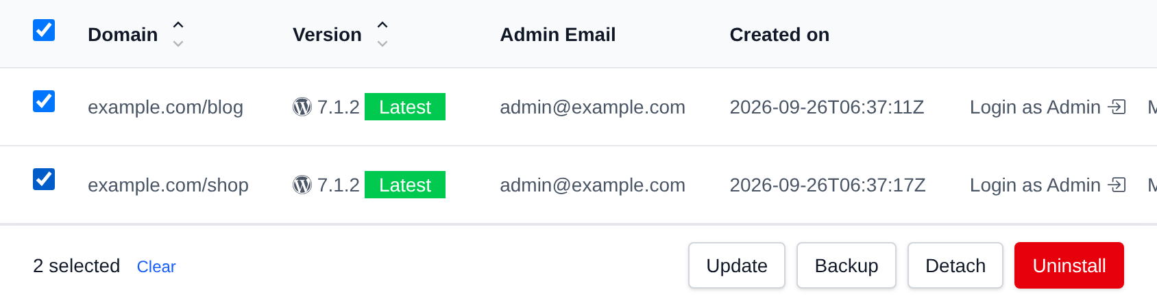 Two WordPress sites selected in the table view with the bulk actions bar offering Update, Backup, Detach and Uninstall